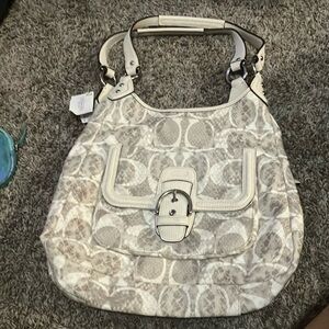 It is a coach tan bag